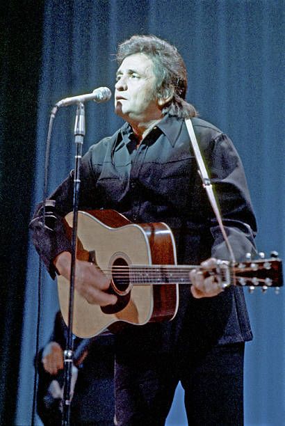 Johnny Cash performing on stage during the 1960s